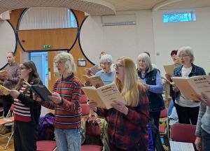a few singers standing Quinborne Choir South West Birmingham